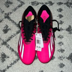 Pink soft ground soccer cleats.